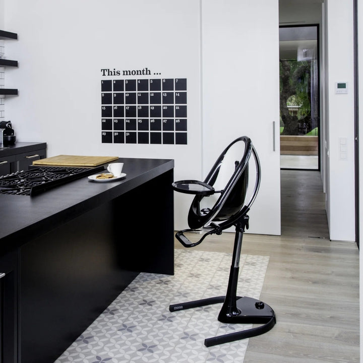 MIMA MOON BLACK HIGH CHAIR WITH WHITE SEAT PAD.